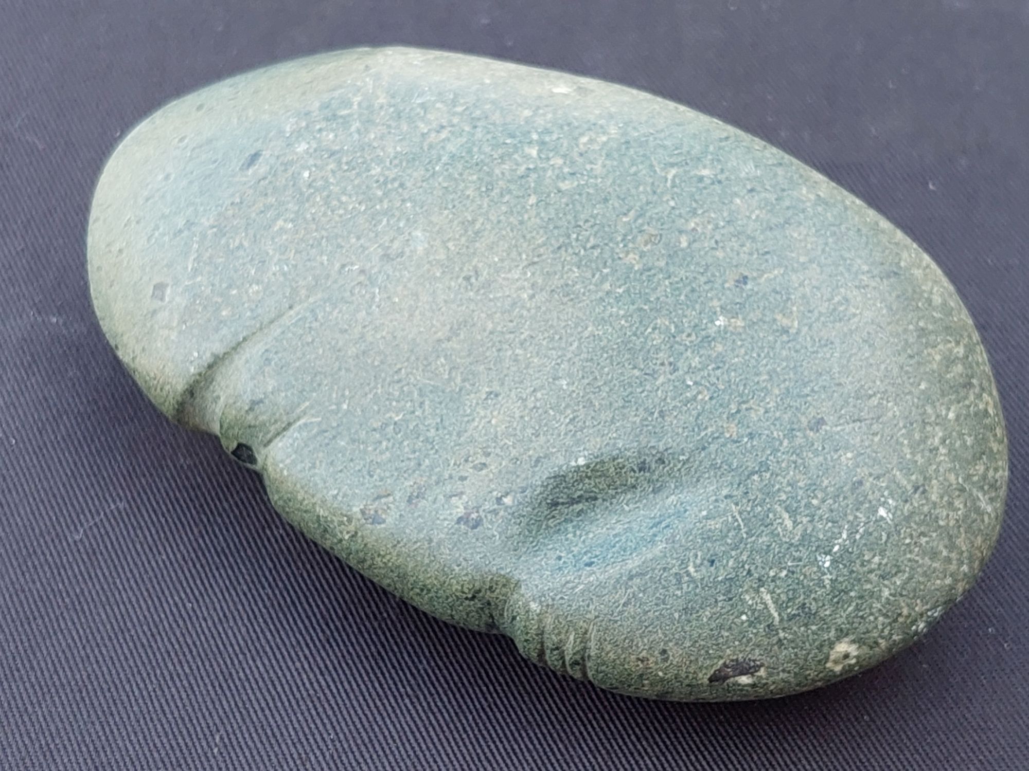 Polished grey stone with facial features