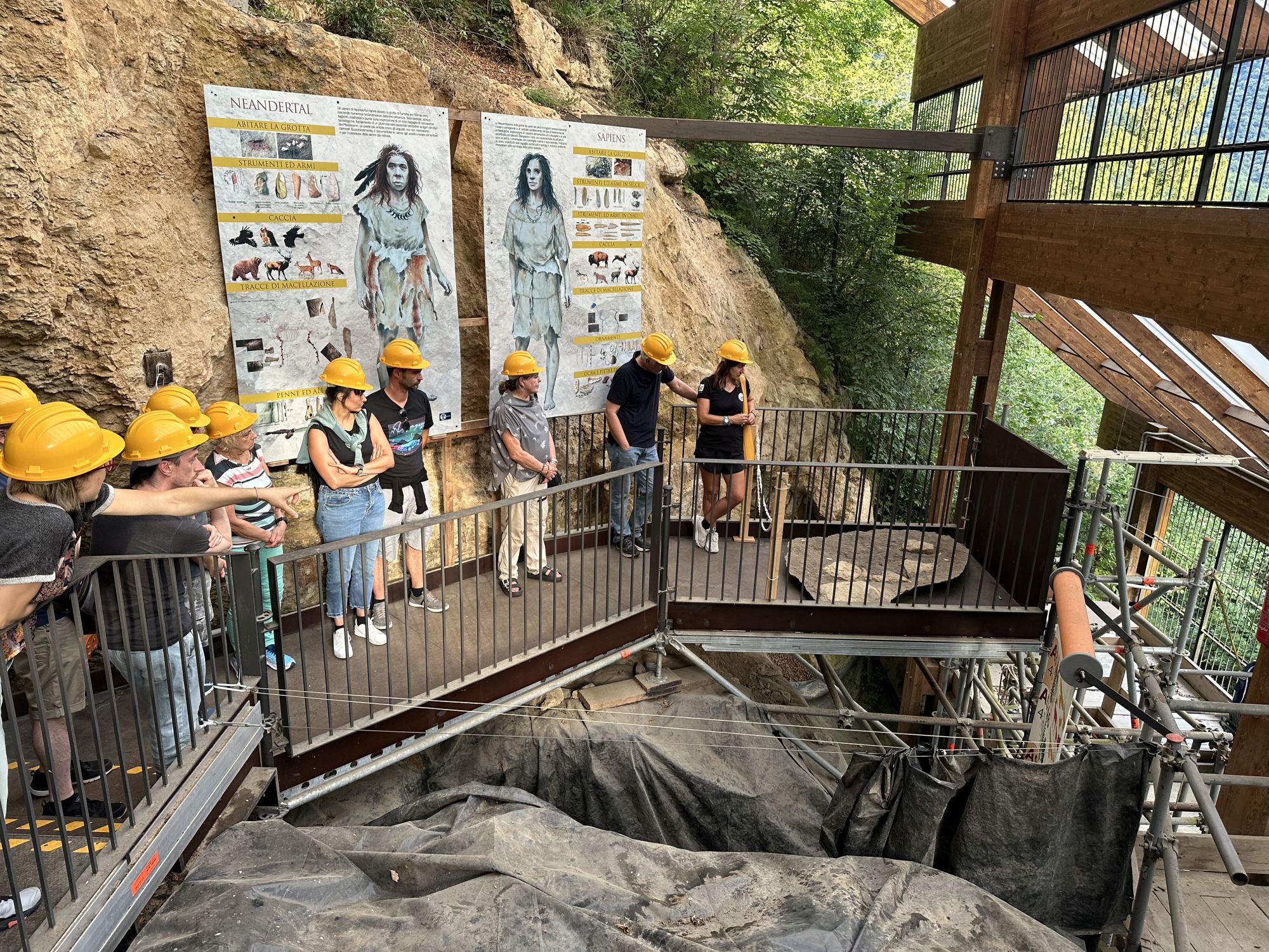 A group of visitors with hard hats in the cave