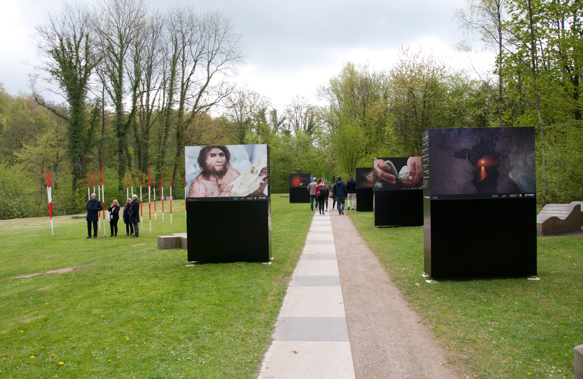 Large photo panels on a meadow, in between visitors