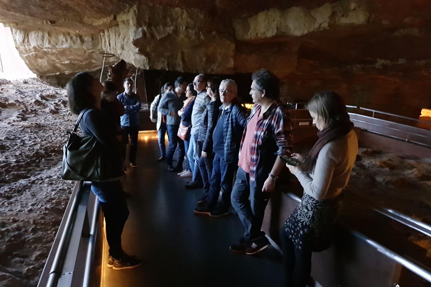 A group admiring a cave replica